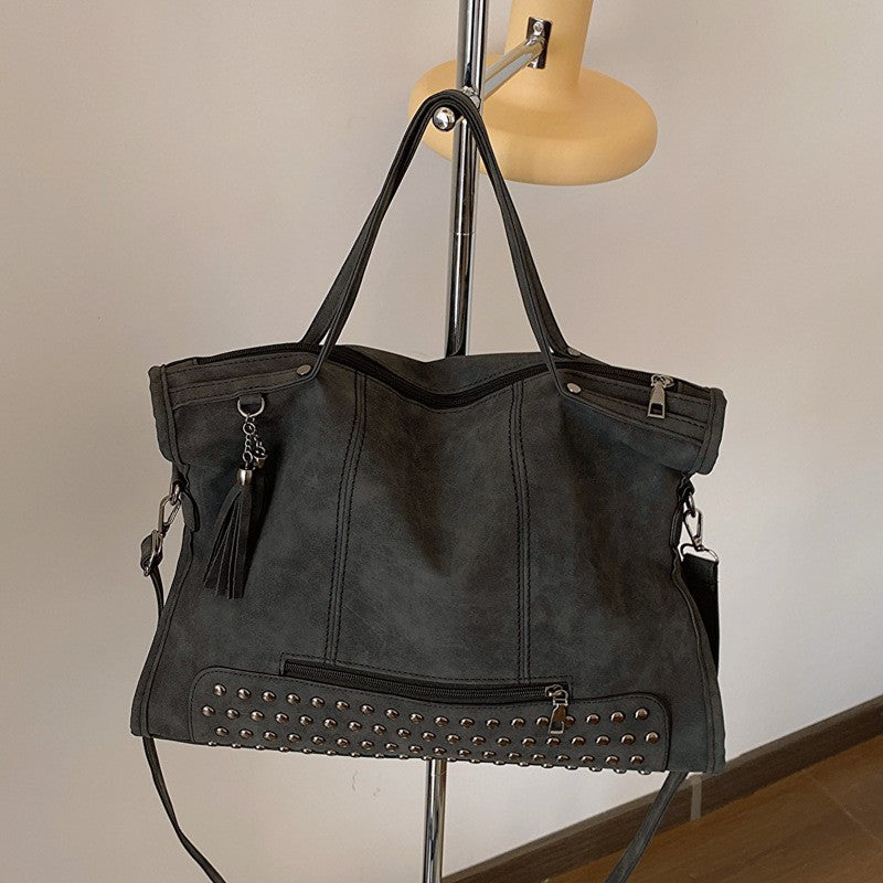 Studded Slouchy Tote Bag with Tassel Charm - Black