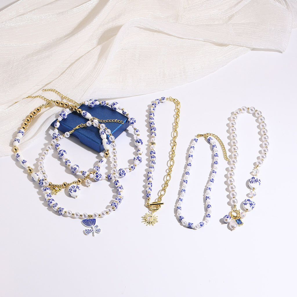 Ceramic flower and pearl necklace collection flat lay