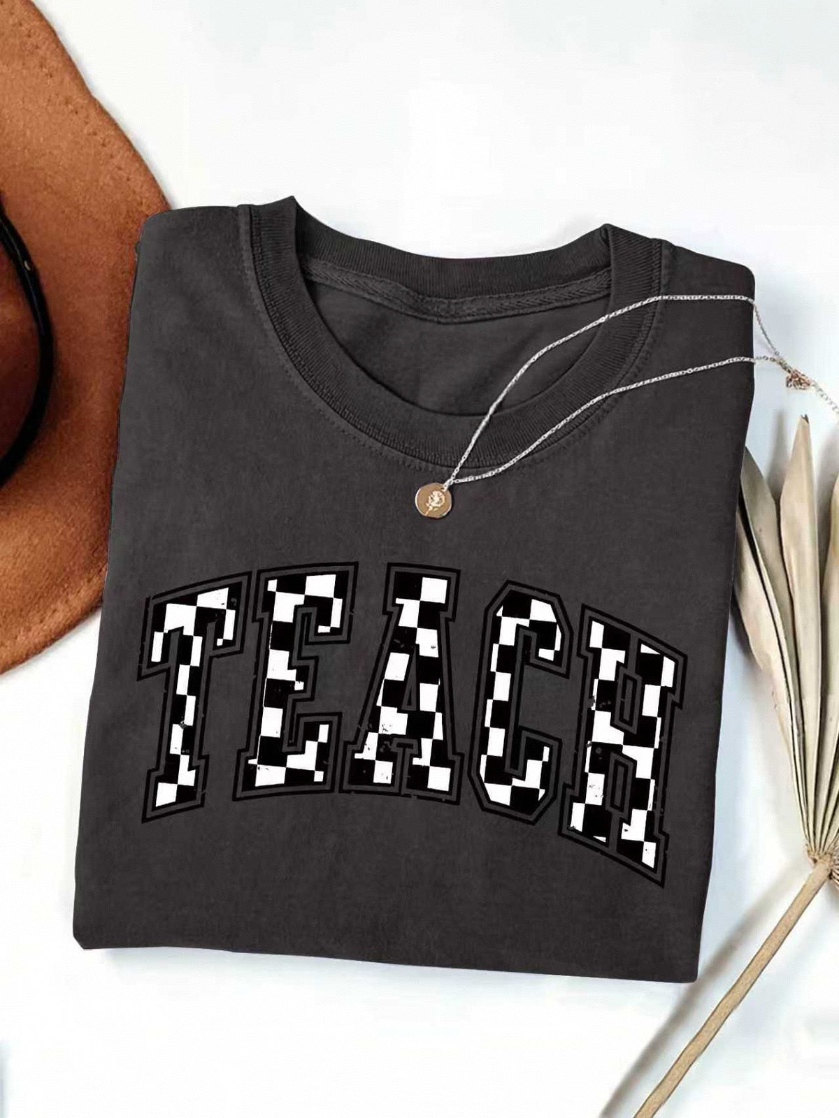 Checkerboard Teach Letter Print Teacher Tee - Black