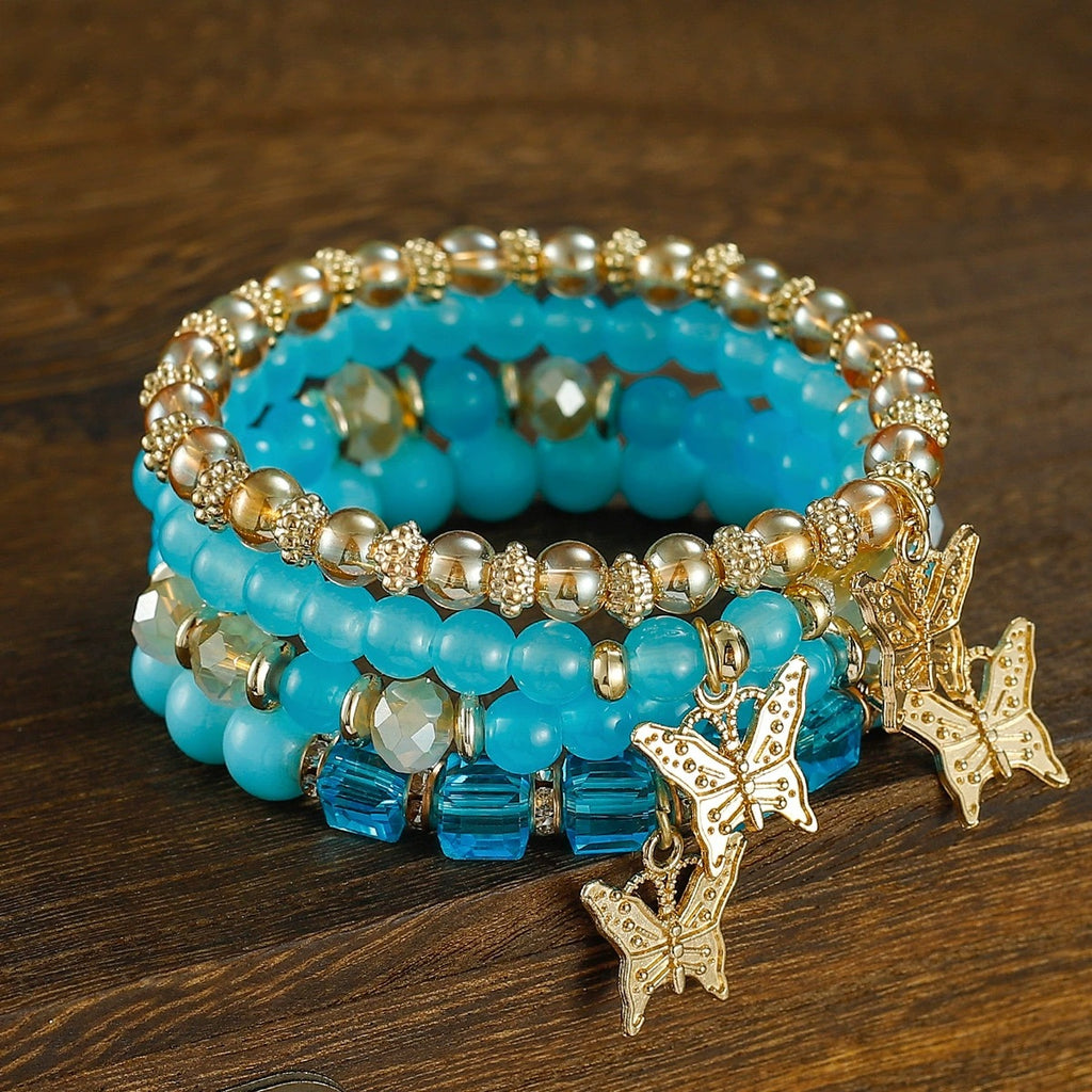 Stacked Bead Coil Bracelet With Butterfly Drops - Blue