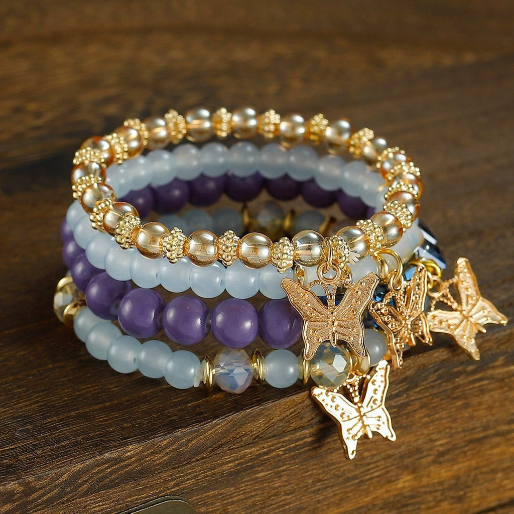 Stacked Bead Coil Bracelet With Butterfly Drops - Purple