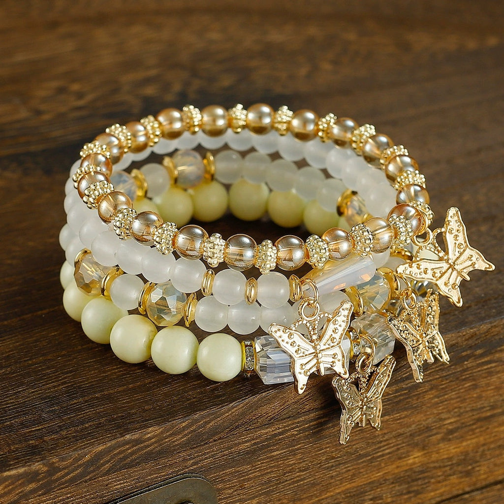 Stacked Bead Coil Bracelet With Butterfly Drops - White
